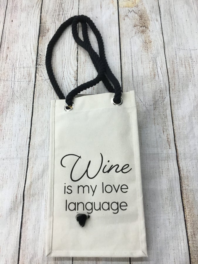 Cocopop Wine is My Love Language Wine BagCanvas wine bag with cute little tassle detail and rope style handles. Would make a great gift!